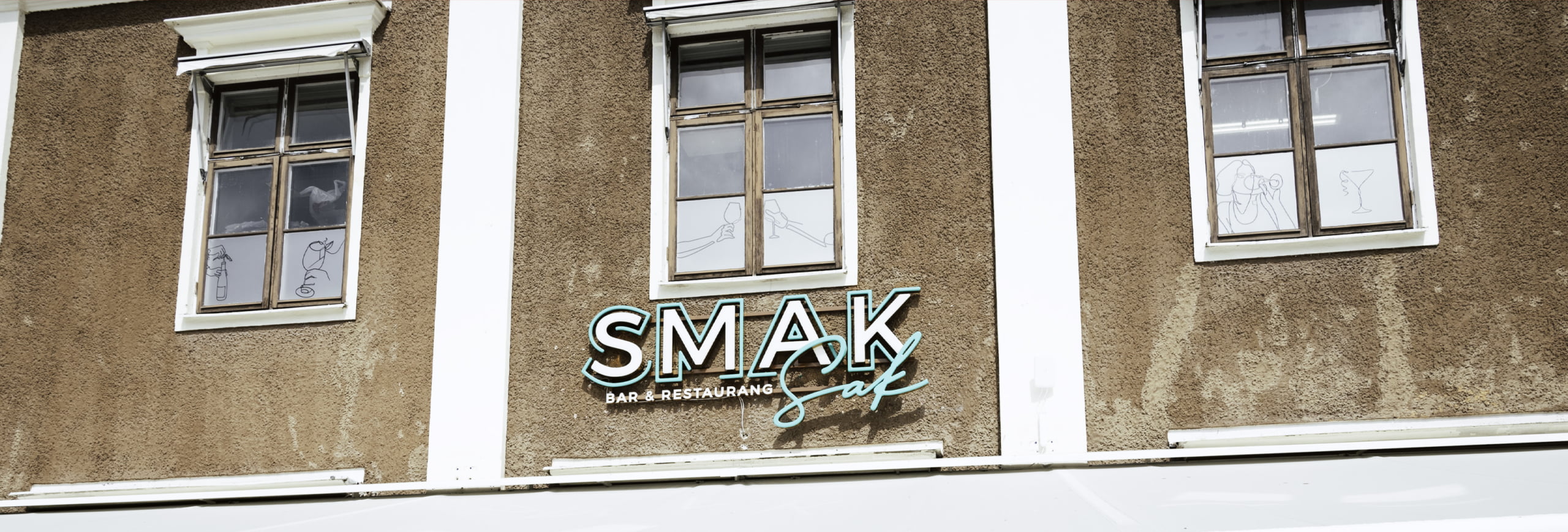 Skylt för SMAK Bar och Restaurang på en fasad i Linköping